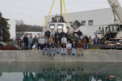 Naval Surface Warfare Center, Carderock Division engineers and technicians who supported the development and testing of NASA’s Orion capsule model pose at Carderock’s test pond