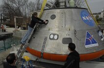 Engineer Lauren “Tink” Hanyok conducts final checks on the hatch mechanism of an Orion capsule test article at Naval Surface Warfare Center, Carderock Division’s test pond