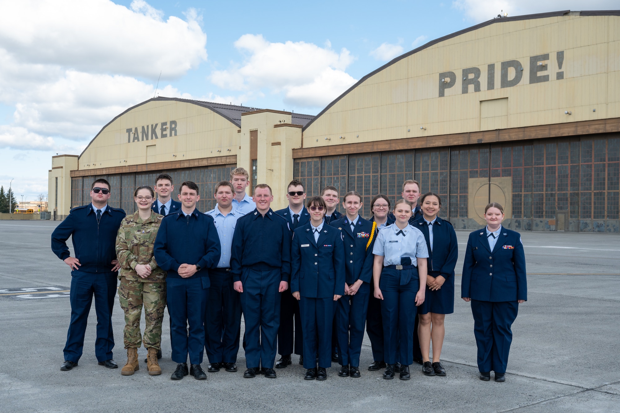 U.S. Force Junior Reserve Officers' Training Corps students from Clarkston High School stand in front of the hangars at Fairchild Air Force Base, Washington.