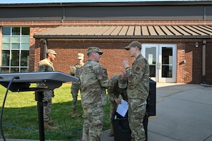 U.S. Air National Guard Staff Sgt. Thomas Akers, 134th Air Refueling Wings, Communications Squadron, right, and U.S. Air Force Master Sgt. Chad Davis, I.G. Brown Training and Education Center, Cyber Operations, left, discuss testing the Starlink satellite system capabilities, April 9, 2026, McGhee Tyson Air National Guard Base, Tennessee. The event, called Operational Signal Ridge, focused on teamwork, communication, and cross-training between the two units. (U.S. Air National Guard photo by Master Sgt. Regina Young)