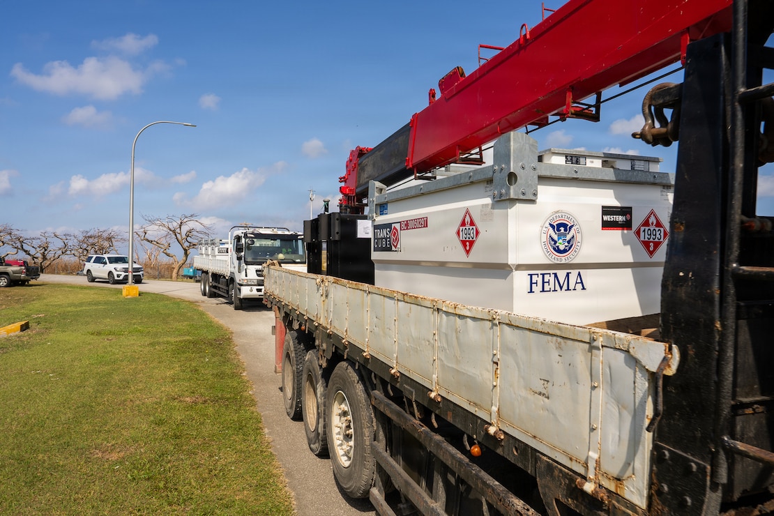 a fuel tank sits on the back of a flatbed truck