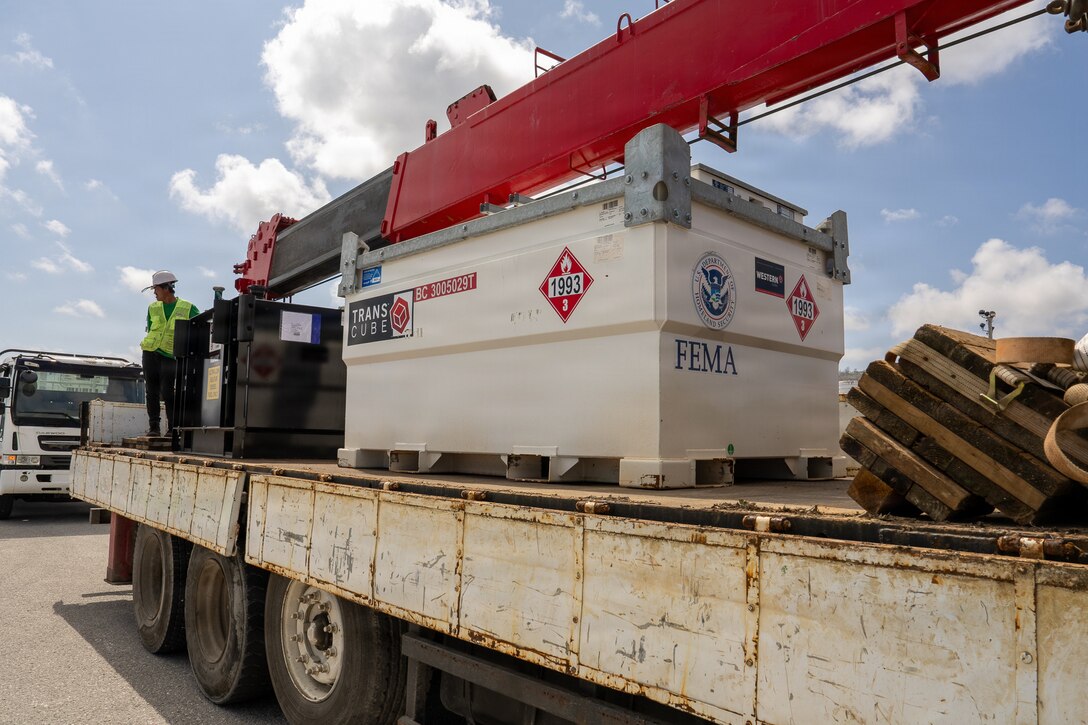 a large fuel tank for a generator sits on a flatbed truck.