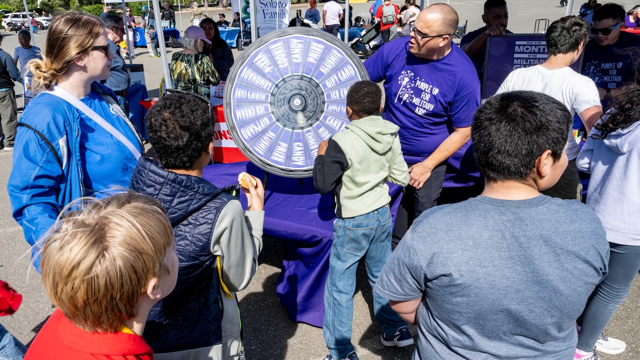 Families participate in “Spin to Win” game at the Family Fun Fest