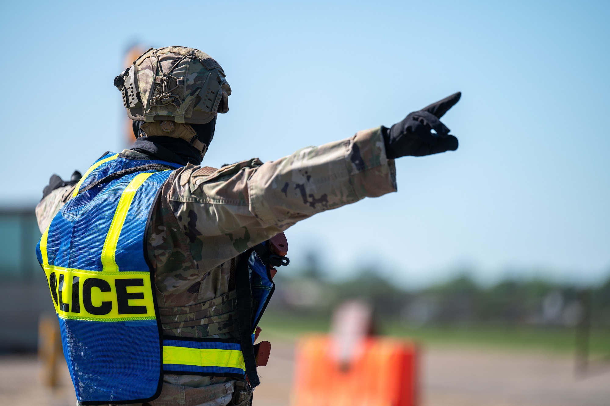 U.S. Air Force Senior Airman Christopher Collis, 42d Security Forces Squadron noncommissioned officer in charge of reports and analysis, directs traffic during an active shooter exercise at Maxwell Air Force base, April 15, 2026. The event was part of MAXFORCE 26-02, a quarterly exercise designed to test the readiness and responses of base personnel to emergency situations. (U.S. Air Force photo by Staff Sgt. Evan Porter)
