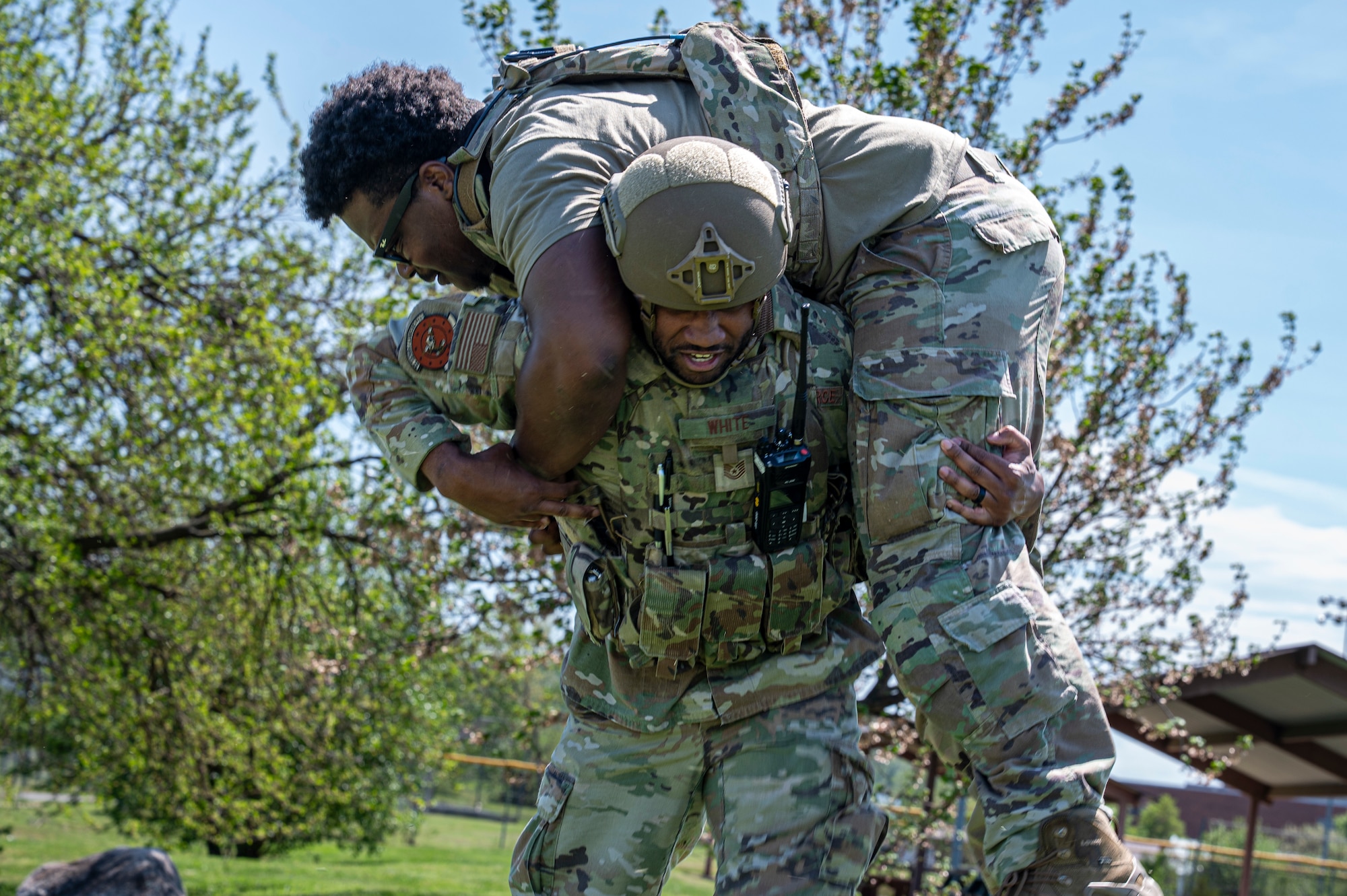 U.S. Air Force Tech. Sgt. Terence White, base defense operations controller with the 11th Security Forces Squadron, carries Senior Airman Shamar Cofield, patrolman with the 11th SFS, during a combat exercise at Joint Base Anacostia-Bolling, Washington, D.C., April 14, 2026. The combat exercise focused on communication skills within the squadron in hostile environments. (U.S. Air Force photo by Senior Airman Shanel Toussaint)