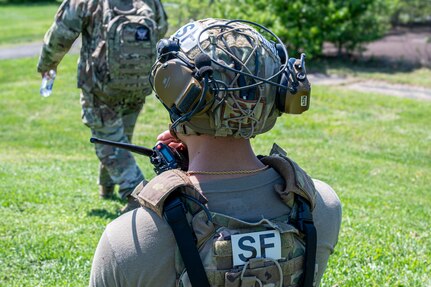 U.S. Air Force Staff Sgt. Keri Rimas, base defense operations controller with the 11th Security Forces Squadron, directs security force members during a combat exercise at Joint Base Anacostia-Bolling, Washington, D.C., April 14, 2026. The team demonstrated tactical movement and communication in a hostile environment. (U.S. Air Force photo by Senior Airman Shanel Toussaint)
