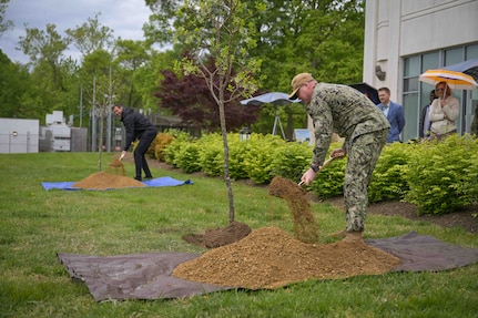 Naval Surface Warfare Center, Carderock Division Infrastructure Division Head, Adam Scates, and XO CDR Jerry Lettich plant white fringe trees in honor of Earth Day outside of the Raye Montague Center courtyard