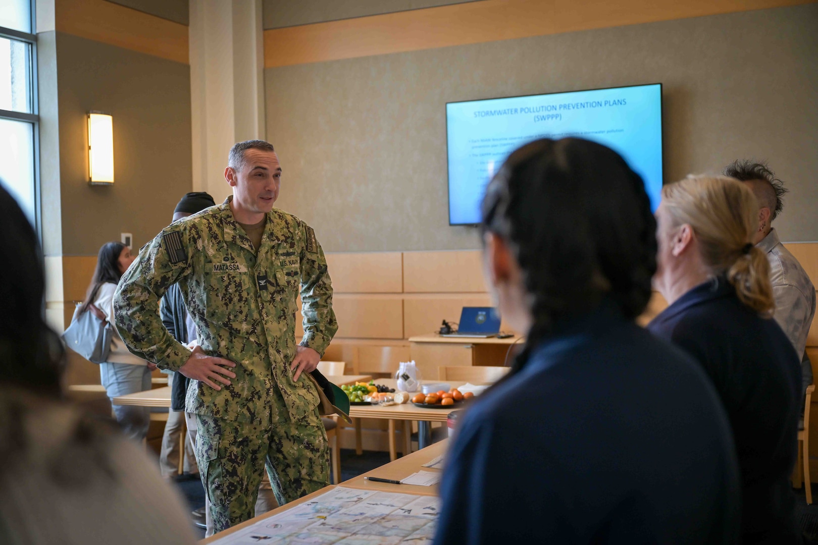 Naval Surface Warfare Center, Carderock Division Commanding Officer, Capt. Chris Matassa, speaks with employees from the environmental office