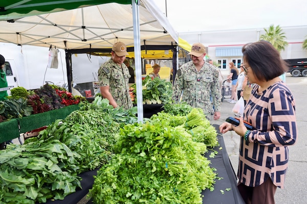 Hospital Corpsman 1st Class Raphael R. Claxton (left) and Hospital Corpsman 1st Class Sean Weimer (right) conduct food safety inspections at the 29 Palms Farmers Market at Marine Corps Air Ground Combat Center (MCAGCC), April 9, 2026. Preventive medicine technicians ensure vendors comply with Navy and Department of War food safety standards, supporting the health and readiness of service members and their families. (U.S. Navy photo by Christopher Jones, NMRTC/NH Twentynine Palms public affairs officer)
