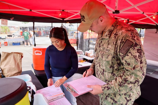 Hospitalman Apprentice Wilson Current (right) inspects a new vendor at the 29 Palms Farmers Market at Marine Corps Air Ground Combat Center (MCAGCC), April 9, 2026. Preventive medicine technicians ensure vendors comply with Navy and Department of War food safety standards, supporting the health and readiness of service members and their families. (U.S. Navy photo by Christopher Jones, NMRTC/NH Twentynine Palms public affairs officer)