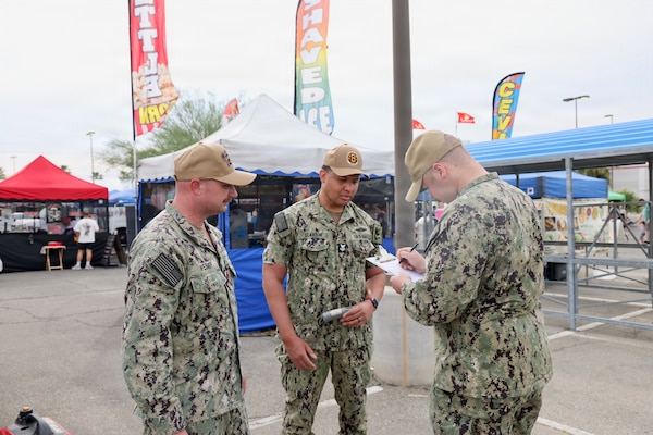 Hospital Corpsman 1st Class Sean Weimer (left), Hospital Corpsman 1st Class Raphael R. Claxton (center), and Hospitalman Apprentice Wilson Current conduct food safety inspections at the 29 Palms Farmers Market at Marine Corps Air Ground Combat Center (MCAGCC), April 9, 2026. Preventive medicine technicians ensure vendors comply with Navy and Department of Defense (Department of War) food safety standards, supporting the health and readiness of service members and their families. (U.S. Navy photo by Christopher Jones, NMRTC/NH Twentynine Palms public affairs officer)