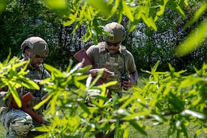 From left, U.S. Air Force Tech. Sgt. Terence White, and Staff Sgt. Dylan Clay, both base defense operations controllers with the 11th Security Forces Squadron, communicate during a tactical training event at Joint Base Anacostia-Bolling, Washington, D.C., April 14, 2026. The team showcased the readiness and preparedness of the squadron in combat environments during the training event. (U.S. Air Force photo by Senior Airman Shanel Toussaint)