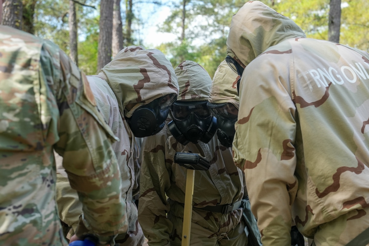 Airmen look at an M8 paper during training