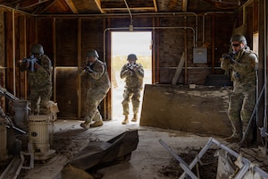Senior Airman Kendrick Johnson, Senior Airman Chase Delamar, Airman 1st Class Mason Land and Senior Airman Kristian Snoots, all from the 412th Maintenance Squadron clear a room during the annual Advanced Combat Training Exercise Close Quarters Battle Course at Edwards Air Force Base, California, April 2, 2026. (Air Force photo by Ariana Ortega)