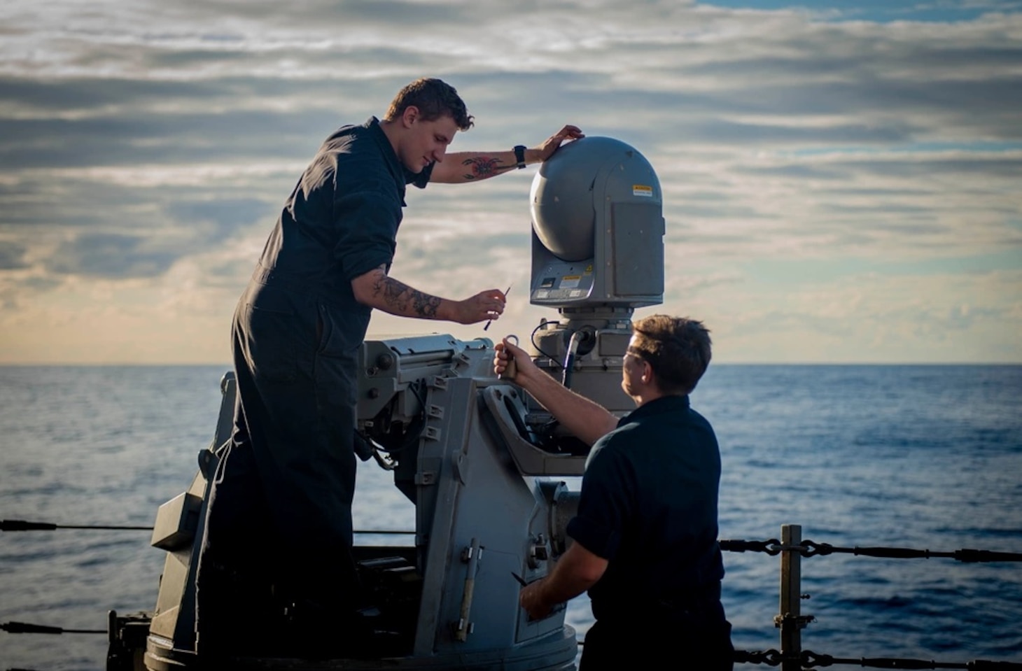 USS Hopper (DDG 70) Sailors Perform Maintenance on a shipboard weapons system in the Pacific Ocean