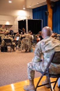 Chief MSgt. watches rehearsal.