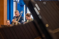 Man plays trombone.