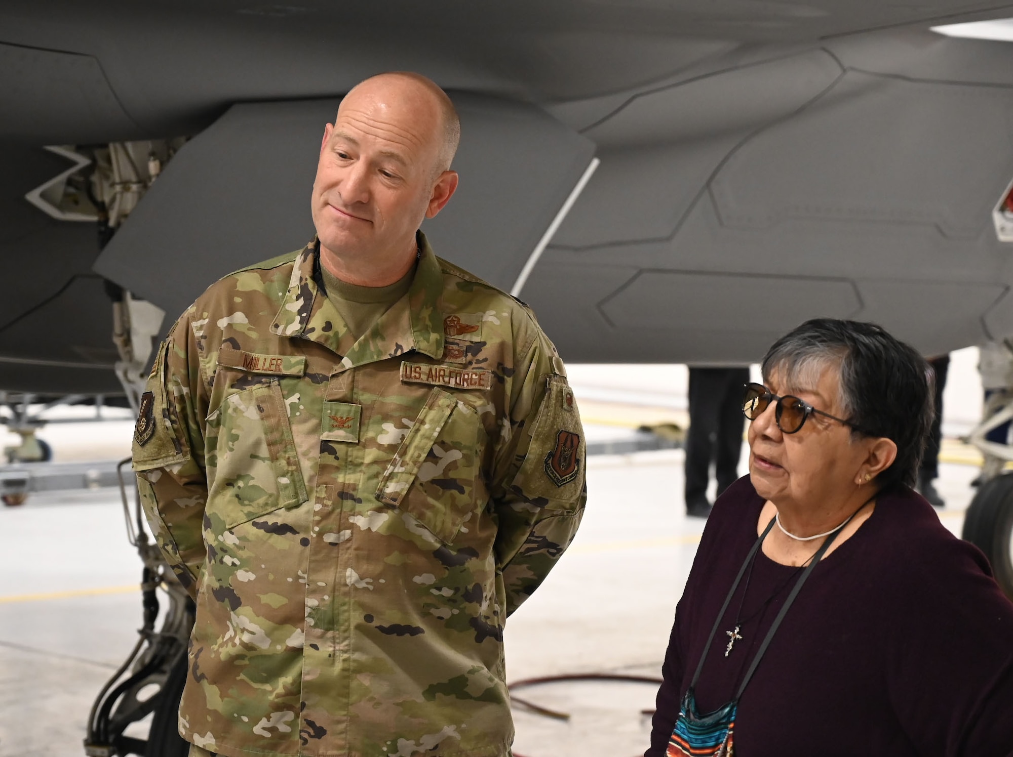 Col. Mathew Miller, Individual Mobilization Augmentee to the 75th Air Base Wing commander, and Andrea Woods, vice chair of the Wells Band of Western Shoshone of the Te-Moak Tribe, soak in information on the F-35 during a tour of the jets at the 2026 Annual American Indian Meeting. (US Air Force photo by Kendahl Johnson)