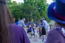 Children walk down to school in celebrating of the Month of the Military Child.