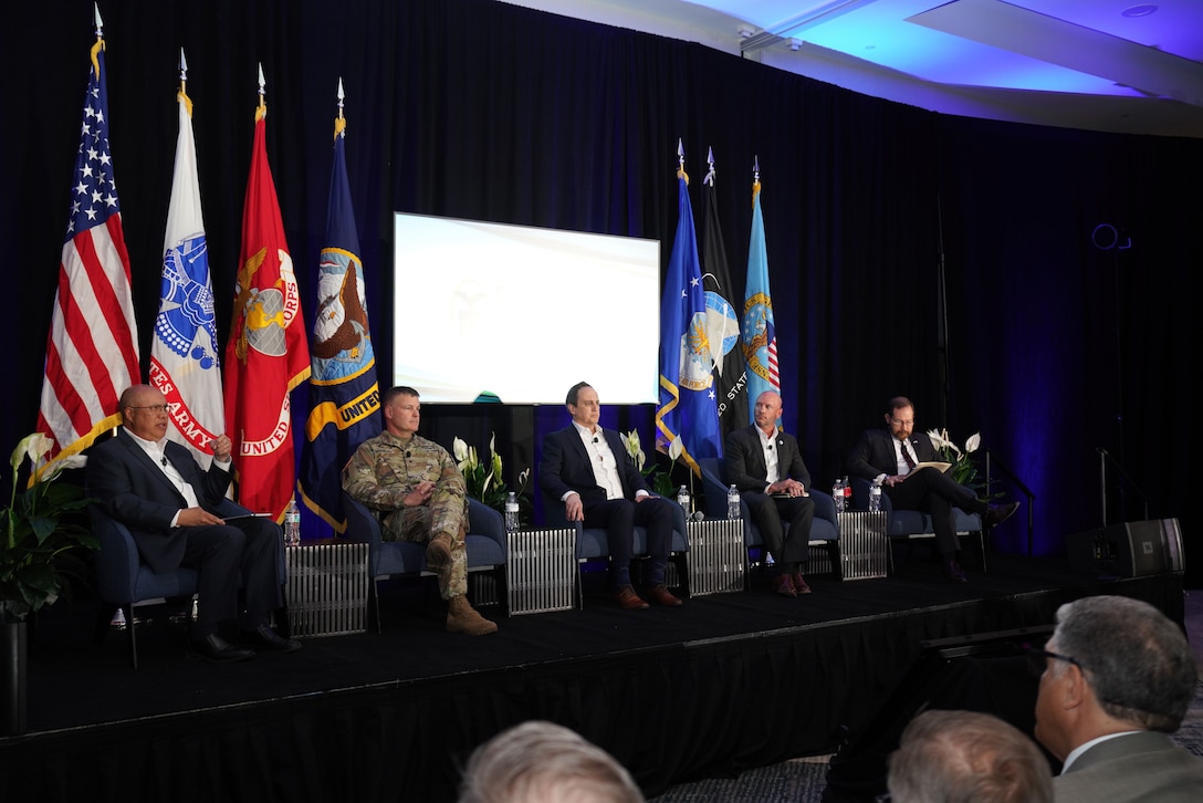 Several people have a discussion during a panel.