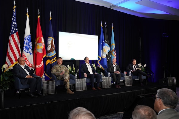 Several people have a discussion during a panel.