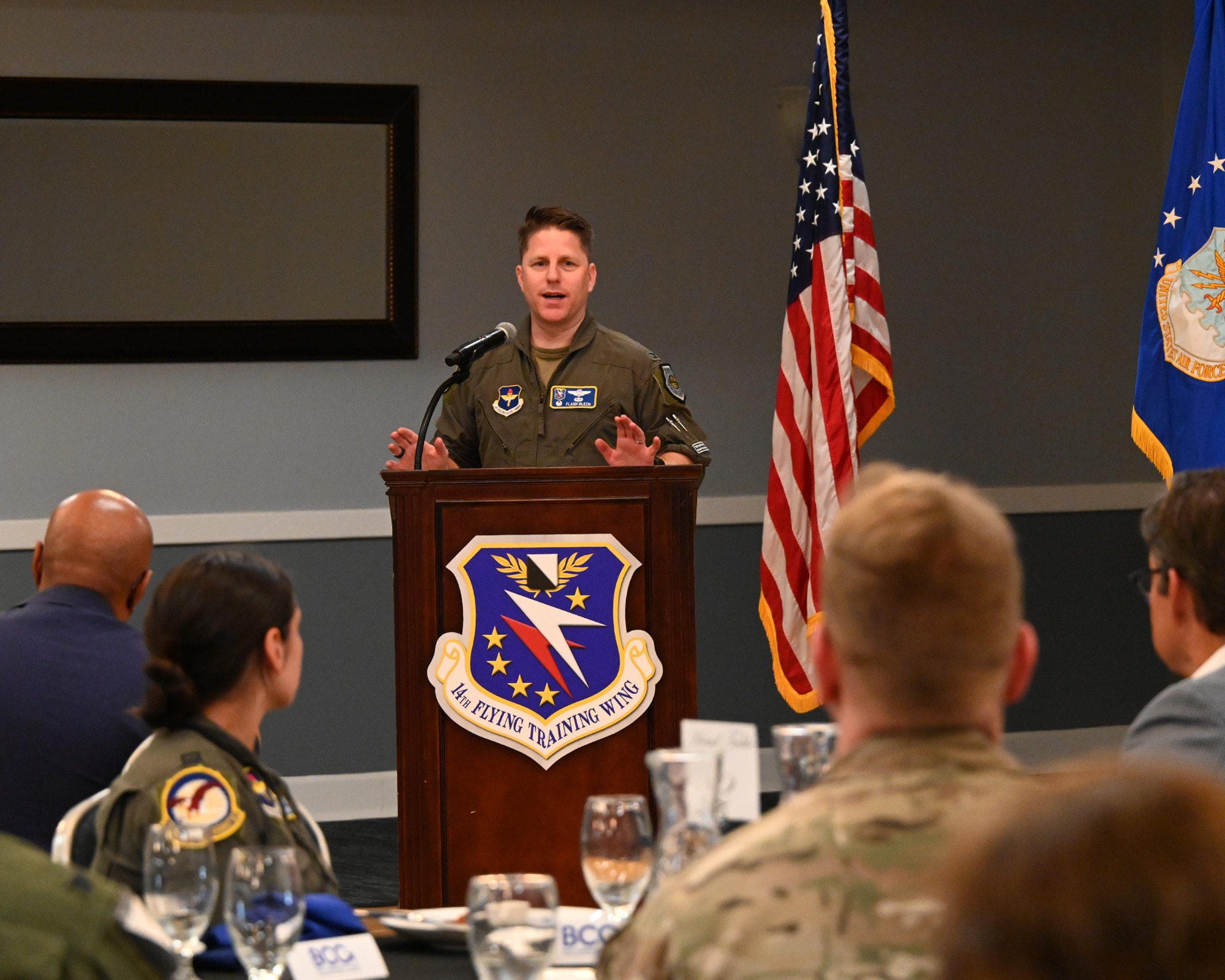 Commander of the 14th Flying Training Wing addresses the community and base personnel during a BCC luncheon.