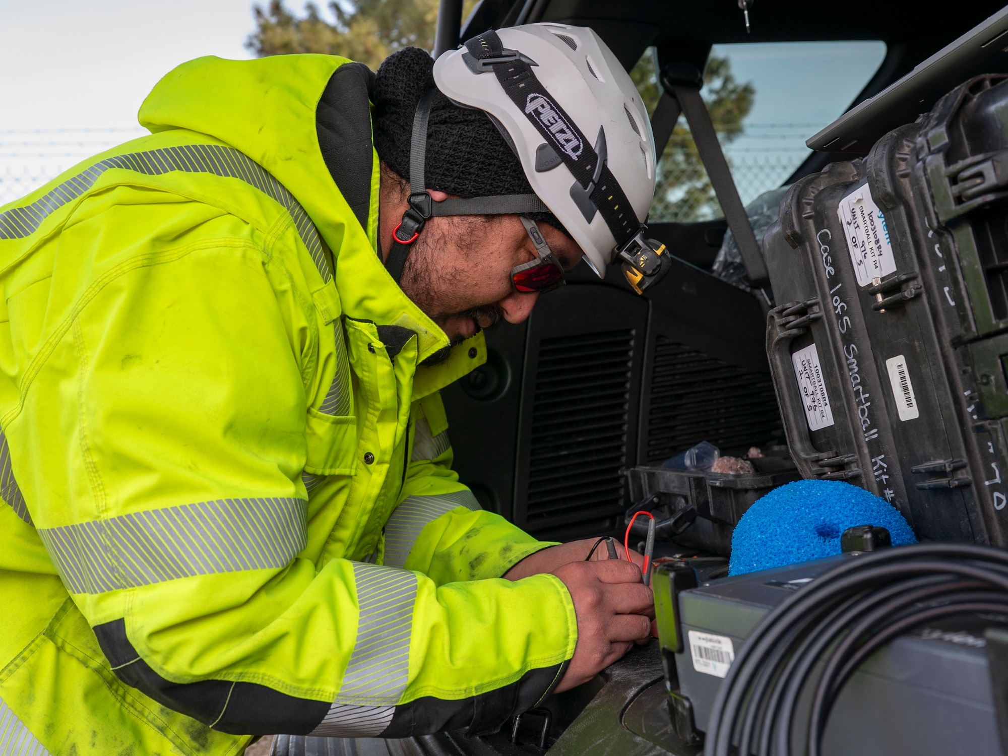 Contractors insert a device into a pipe.