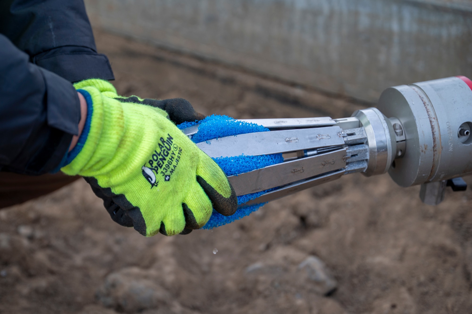 Contractors insert a device into a pipe.