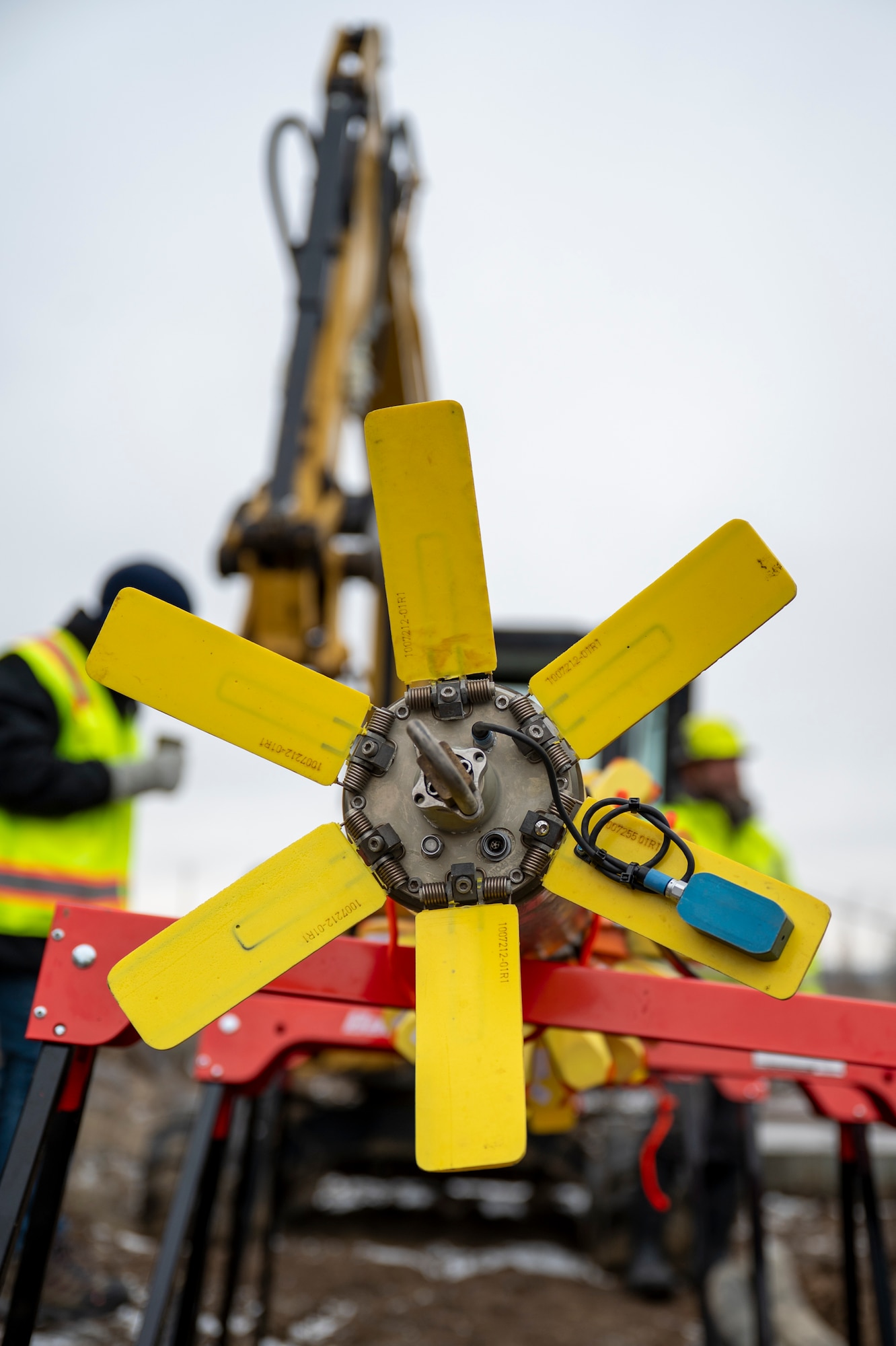 Contractors insert a device into a pipe.