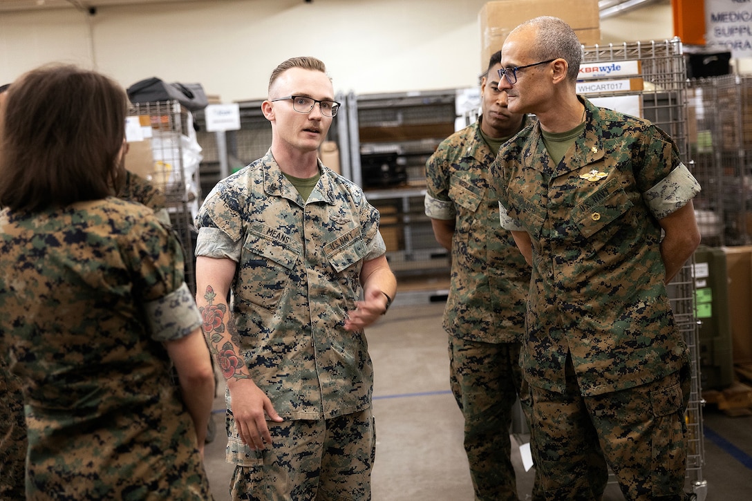 U.S. Navy Petty Officer 2nd Class Owen Means, of Calhoun, Georgia, explains a new stock locator system to U.S. Navy Rear Adm. Guido Valdes, the Medical Officer of the Marine Corps, during a tour April 22, 2026, at Marine Corps Support Facility Blount Island, Florida. The system improves accuracy in tracking equipment and supplies assigned to Marine Corps prepositioning programs worldwide. The Marine Corps’ senior medical advisor and health services director visited Blount Island Command to gain ground-level insight into prepositioned medical capabilities supporting global operations. (Marine Corps photo by Dustin Senger)