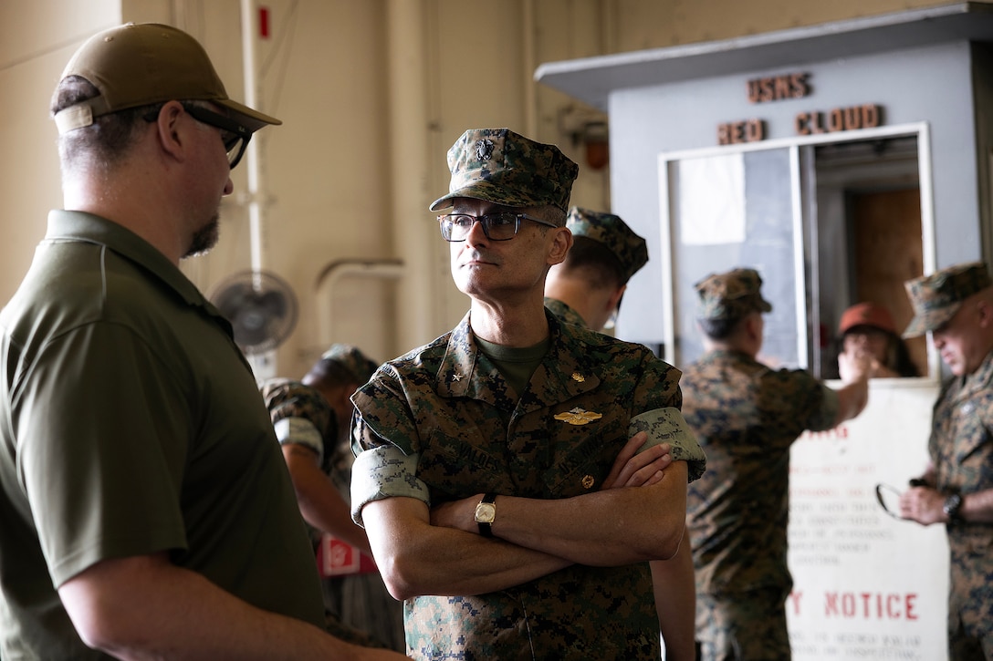 Andrew Macleod, a contracted mariner and captain of the USNS Red Cloud, explains the cargo ship to U.S. Navy Rear Adm. Guido Valdes, the Medical Officer of the Marine Corps, during a tour April 22, 2026, at Marine Corps Support Facility Blount Island, Florida. The Marine Corps’ senior medical advisor and health services director visited Blount Island Command to gain ground-level insight into prepositioned medical capabilities supporting global operations. (Marine Corps photo by Dustin Senger)