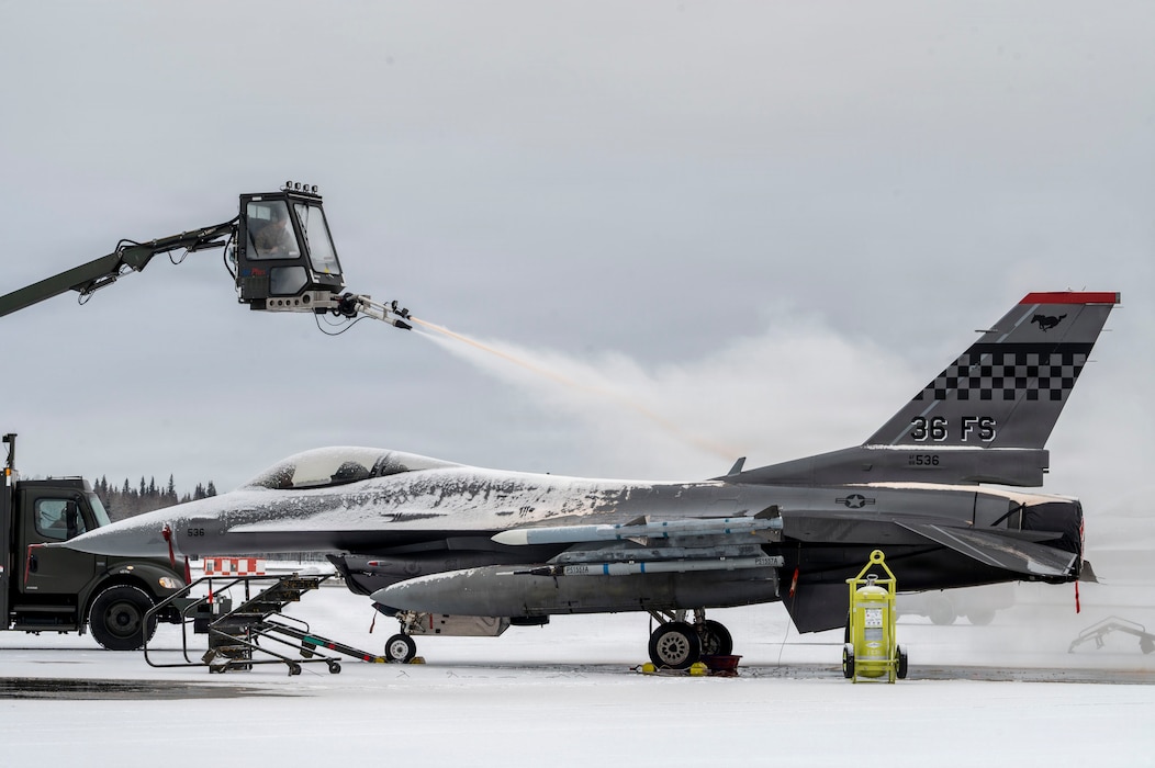 A U.S. Airman with the 354th Civil Engineer Squadron de-ices an F-16 Fighting Falcon before takeoff during Red Flag-Alaska 26-1 at Eielson Air Force Base, Alaska, April 20, 2026.