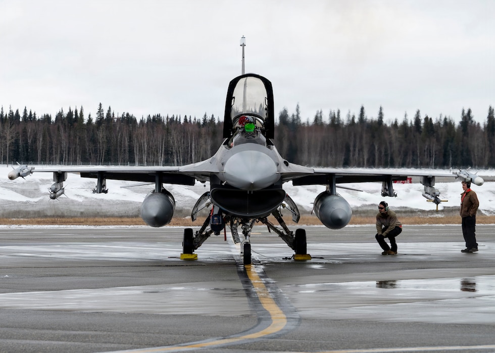 A U.S. Air Force F-16 Fighting Falcon pilot conducts pre-flight inspections on the flight line during Red Flag-Alaska 26-1 at Eielson Air Force Base, Alaska, April 20, 2026.
