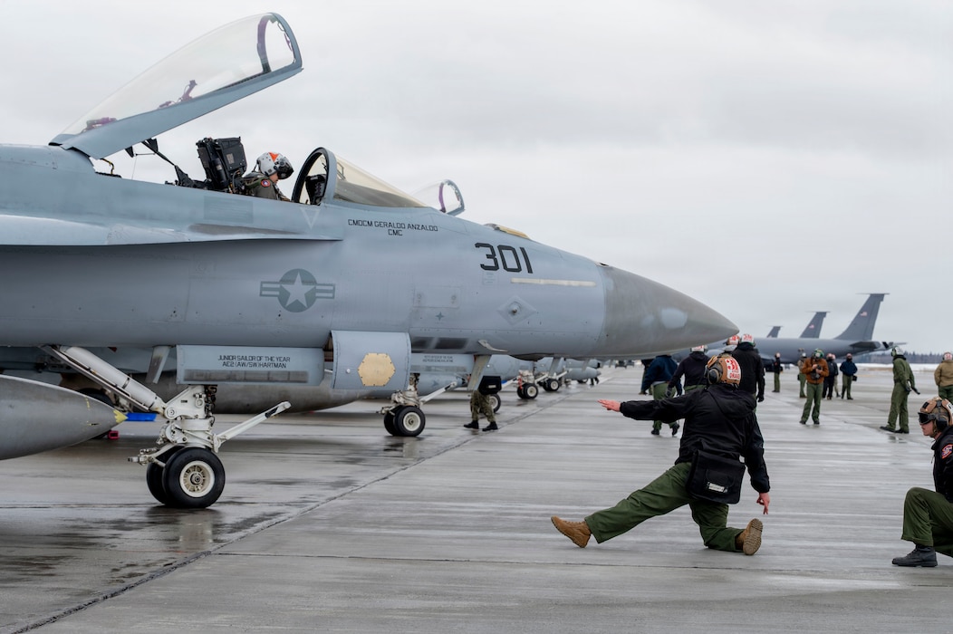 A U.S. Navy service member conducts pre-flight inspections on the flight line during Red Flag-Alaska 26-1 at Eielson Air Force Base, Alaska, April 20, 2026.