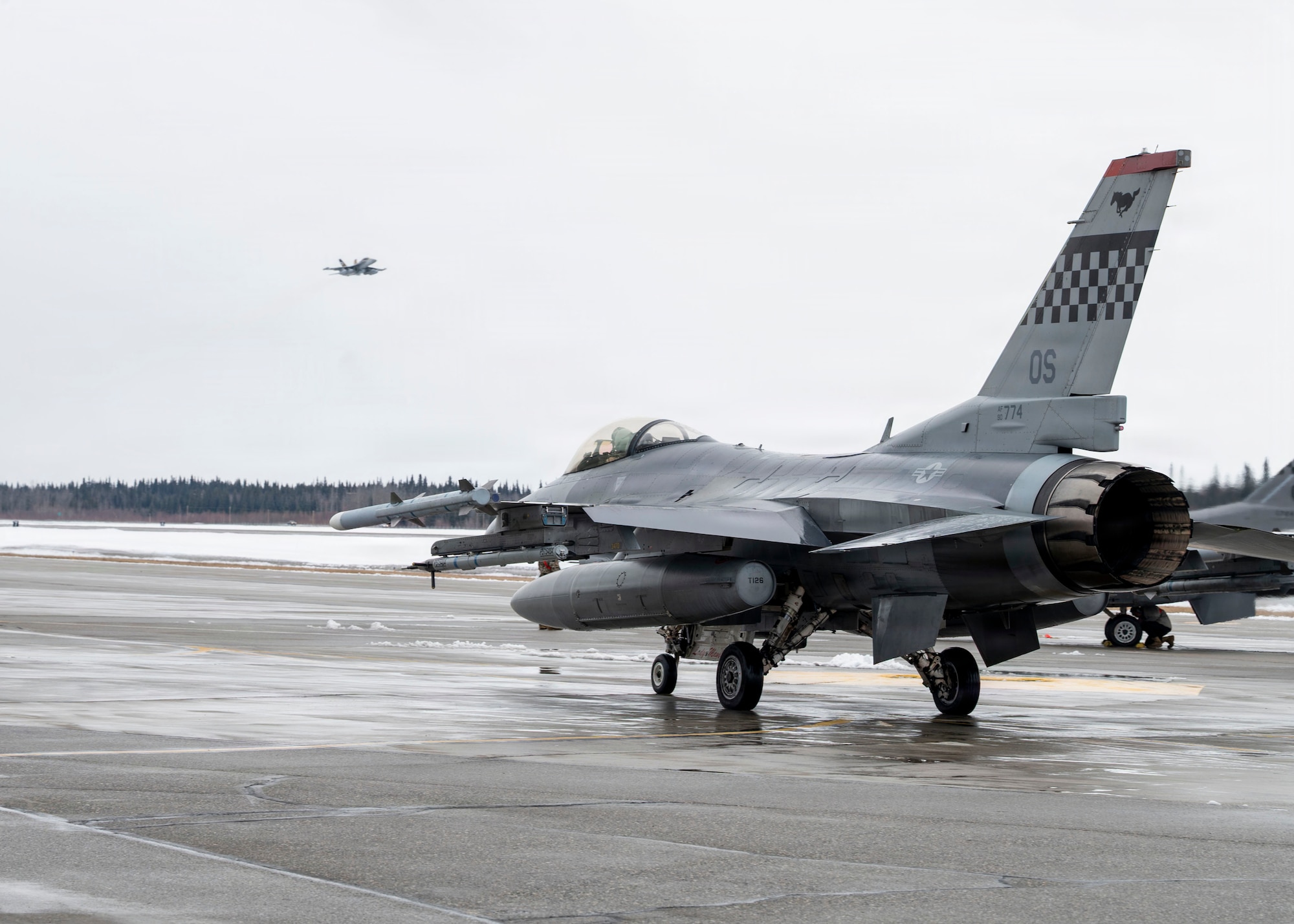 A U.S. Air Force F-16 Fighting Falcon taxis toward the runway before takeoff during Red Flag-Alaska 26-1 at Eielson Air Force Base, Alaska, April 20, 2026.