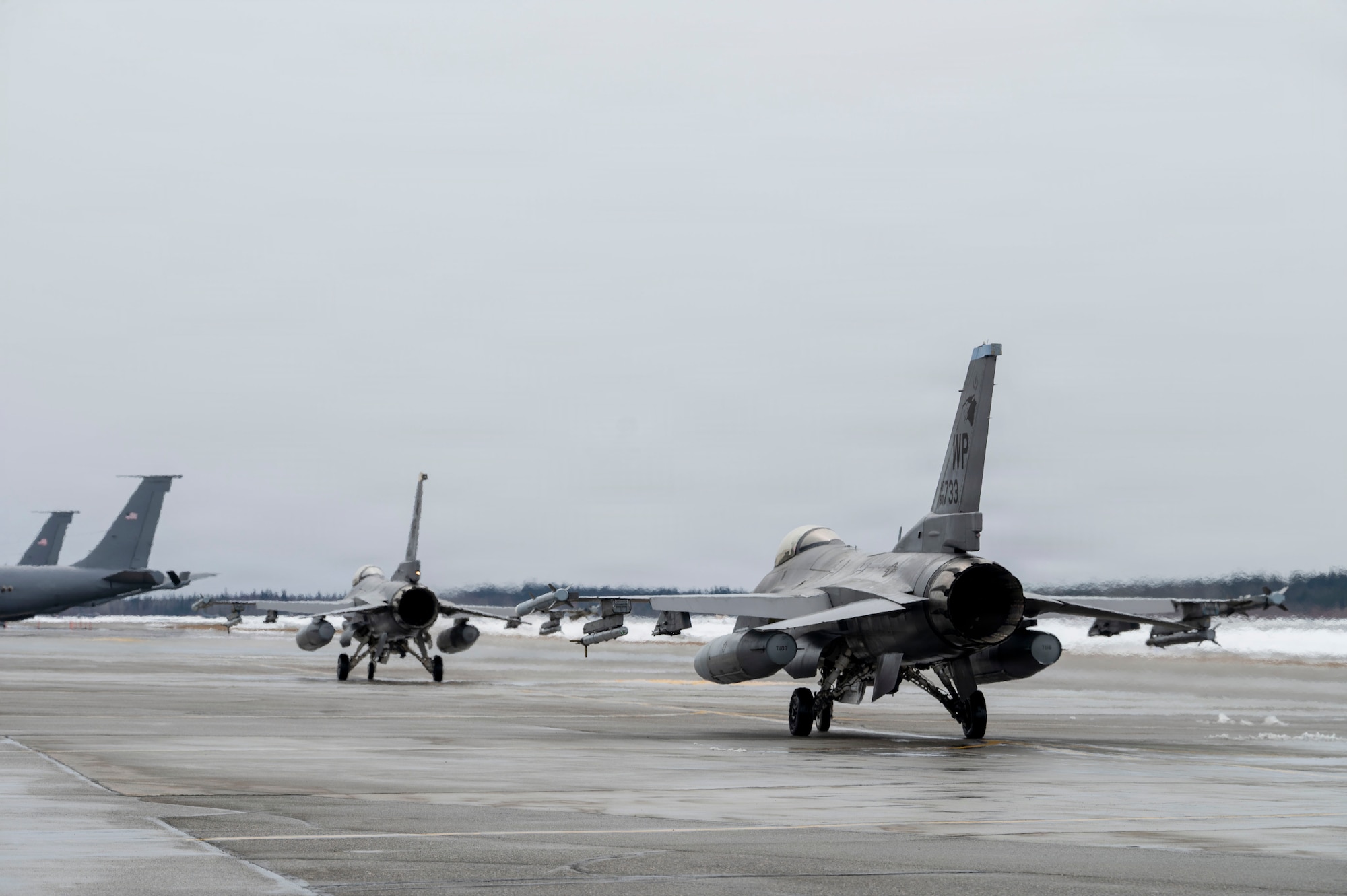 Two U.S. Air Force F-16 Fighting Falcons taxi toward the runway before takeoff during Red Flag-Alaska 26-1 at Eielson Air Force Base, Alaska, April 20, 2026.