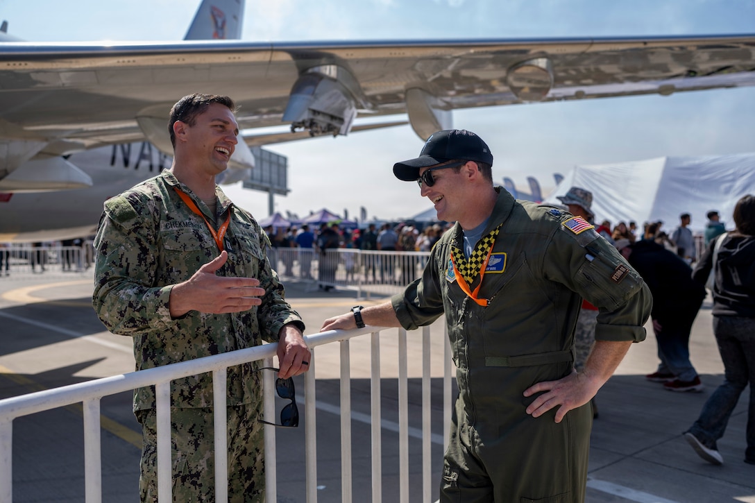 U.S. Navy Lt. Dmitriy Chekmenov, Patrol Squadron Thirty’s Maintenance Material Control Officer, left, talks to U.S. Air Force Lt. Col. Jeff Buddis, Air Boss, during Feria Internacional del Aire y del Espacio (FIDAE) 2026 in Santiago, Chile, April 7, 2026. The P-8 static display provided an opportunity for the U.S. military to engage with the public and share information about U.S. aviation and defense technology. (U.S. Air Force photo by Andrea Jenkins)