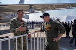U.S. Navy Lt. Dmitriy Chekmenov, Patrol Squadron Thirty’s Maintenance Material Control Officer, left, talks to U.S. Air Force Lt. Col. Jeff Buddis, Air Boss, during Feria Internacional del Aire y del Espacio (FIDAE) 2026 in Santiago, Chile, April 7, 2026. The P-8 static display provided an opportunity for the U.S. military to engage with the public and share information about U.S. aviation and defense technology. (U.S. Air Force photo by Andrea Jenkins)