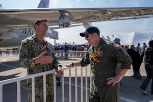 U.S. Navy Lt. Dmitriy Chekmenov, Patrol Squadron Thirty’s Maintenance Material Control Officer, left, talks to U.S. Air Force Lt. Col. Jeff Buddis, Air Boss, during Feria Internacional del Aire y del Espacio (FIDAE) 2026 in Santiago, Chile, April 7, 2026. The P-8 static display provided an opportunity for the U.S. military to engage with the public and share information about U.S. aviation and defense technology. (U.S. Air Force photo by Andrea Jenkins)