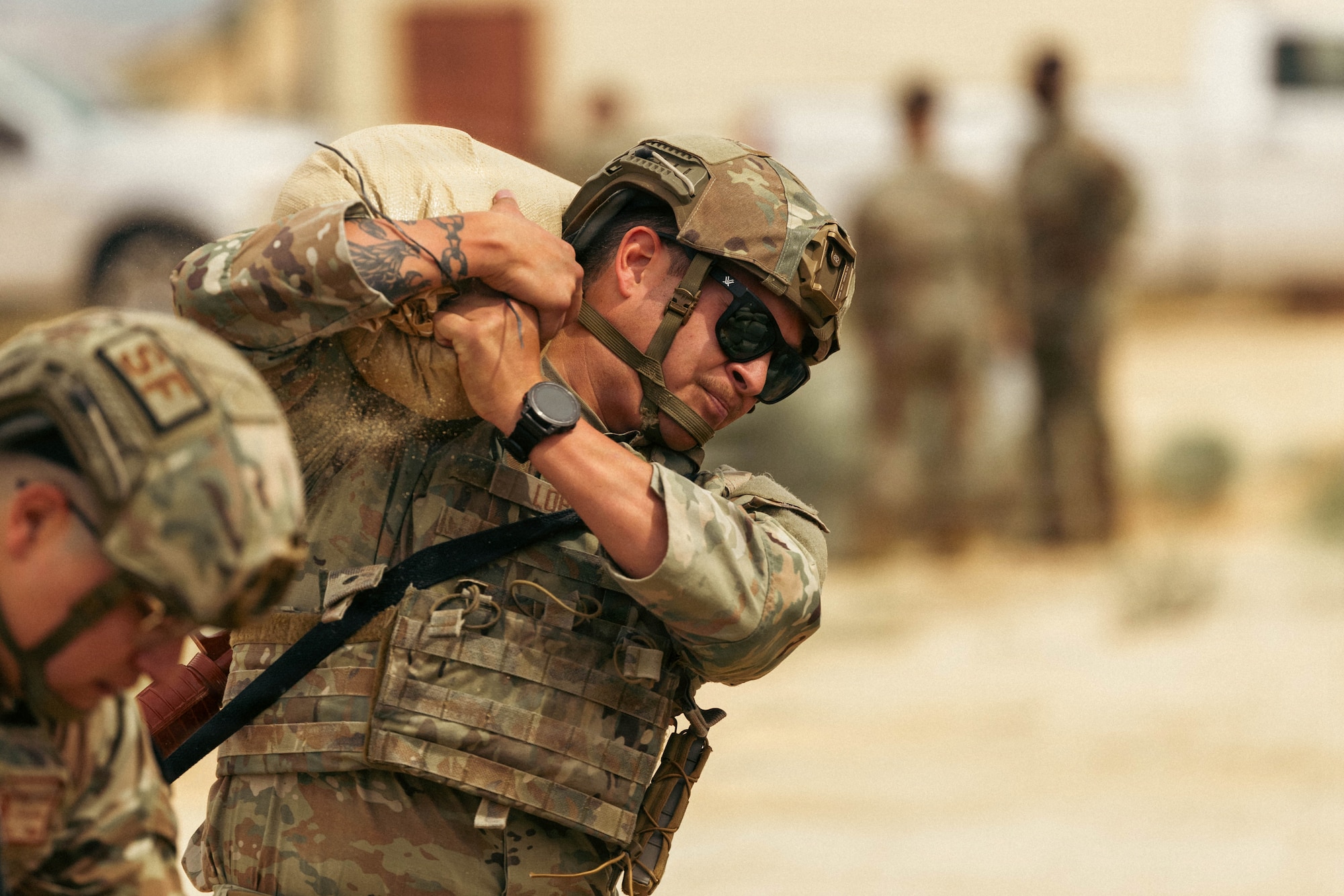 Air Force Staff Sgt. John Lopez, 412th Security Forces Squadron, carries a sandbag during the physical training competition portion of the annual Advanced Combat Training Exercise at Edwards Air Force Base, California, March 30, 2026. (Air Force photo by Brandon Hernandez)