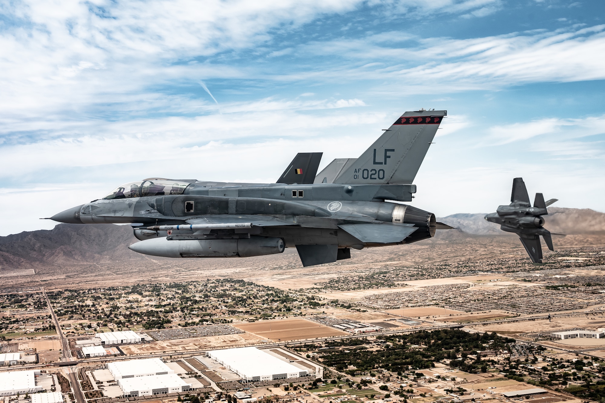 A U.S. Air Force F-35A Lightning II assigned to the 56th Fighter Wing flies out of formation and breaks right while banking over the city of Glendale