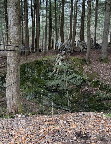 image of an Airman crossing a ravine using a high-line rope system.