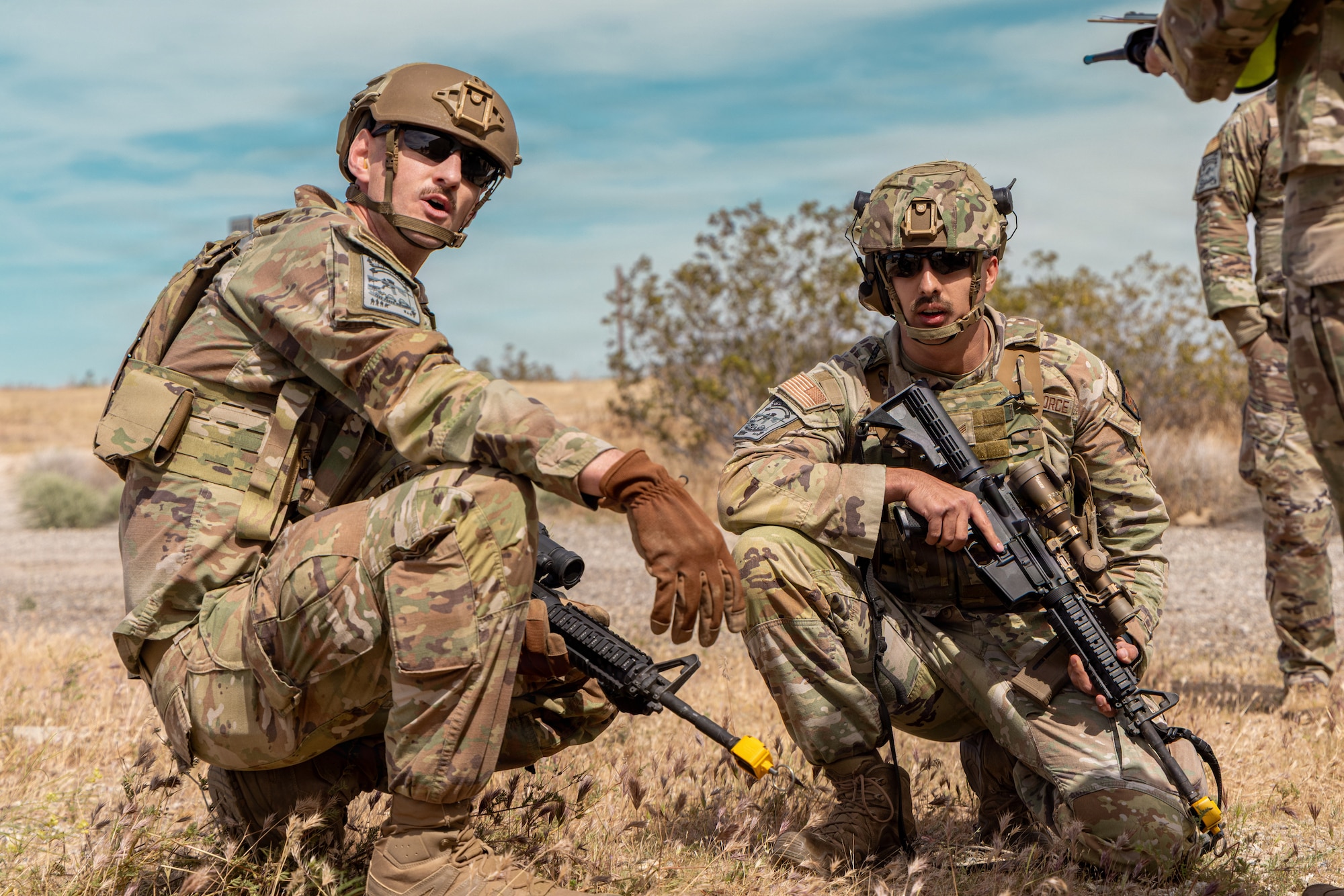 Air Force 1st Lt. Jared C. Barnes and Senior Airman Noah D. Bugiada, both from the 61st Security Forces Squadron our of Los Angeles Space Force Base, plan their next move during the annual Advanced Combat Training Exercise Close Quarters Battle Course at Edwards Air Force Base, California, April 2, 2026. (Air Force photo by Ariana Ortega)