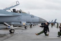 A U.S. Navy service member conducts pre-flight inspections on the flight line during Red Flag-Alaska 26-1 at Eielson Air Force Base, Alaska, April 20, 2026.