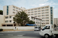 FLEET ACTIVITIES YOKOSUKA, Japan (April 15, 2026) -- Most of the scaffolding is removed from the site for the new Unaccompanied Housing unit near Green Beach Pool as seen April 15, 2026 onboard Commander, Fleet Activities Yokosuka, Japan. The eight-floor, 198-module complex is set to serve approximately 400 Sailors. Additional plans for three more UH complexes are also scheduled as part of an overhaul to expand and modernize housing facilities for unaccompanied Sailors assigned to Yokosuka. Other projects include a $1.3 million flooring renovation, $15 million mechanical and electrical system upgrades, $4 million weather-sealing project, and an unmanned, Navy Exchange Micro-Mart. (U.S. Navy photo by James Kimber)