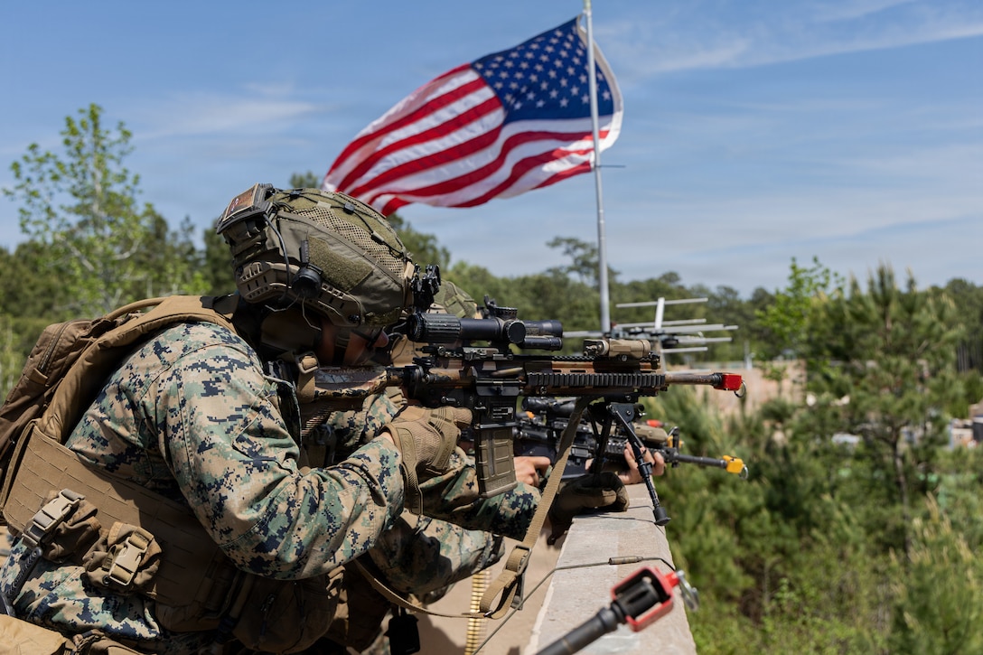 U.S. Marines with 3rd Battalion, 2nd Marine Regiment, 24th Marine Expeditionary Unit, engage simulated adversaries during an embassy reinforcement scenario as part of a MEU exercise on Marine Corps Base Camp Lejeune, North Carolina, April 14, 2026. This exercise sharpened the 24th MEU’s command and control capabilities, ensuring seamless communication and decisive action for our upcoming deployment. (U.S. Marine Corps photo by Lance Cpl. Payton Walley)
