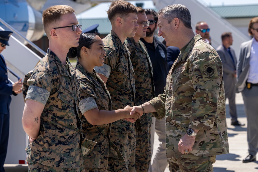 U.S Air Force Gen. John D. Caine, right, the 22nd Chairman of the Joint Chiefs of Staff, gives a coin to U.S. Marine Corps Pfc. Kelly Arjona, aviation ordnance technician with Marine Corps Air Station New River, before departing MCAS New River, North Carolina, April 17, 2026. Gen. Caine visited Marine Corps Base Camp Lejeune and Marine Corps Air Station New River, where he attended a change of command ceremony, engaged with senior leadership, shared a meal with Marines on the air station, and presented coins to recognize excellence and boost morale. (U.S. Marine Corps photo by Cpl. Jessica J. Mazzamuto)