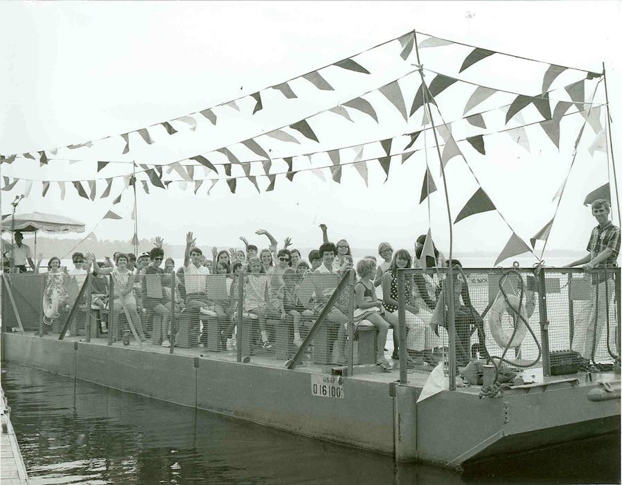 Attendees take part in a boat ride around Woods Reservoir during the annual Arnold Engineering Development Center Family Picnic in 1969. The reservoir, created by the 1952 completion of the Elk River Dam to supply cooling water to AEDC test facilities, opened for public fishing and recreation on May 30, 1953. Public use of the manmade lake was a topic of focus for then-AEDC Commander Brig. Gen. Samuel Harris following construction of the dam and leading up to the dedication of the waterbody as Woods Reservoir in July 1953. (U.S. Air Force photo)