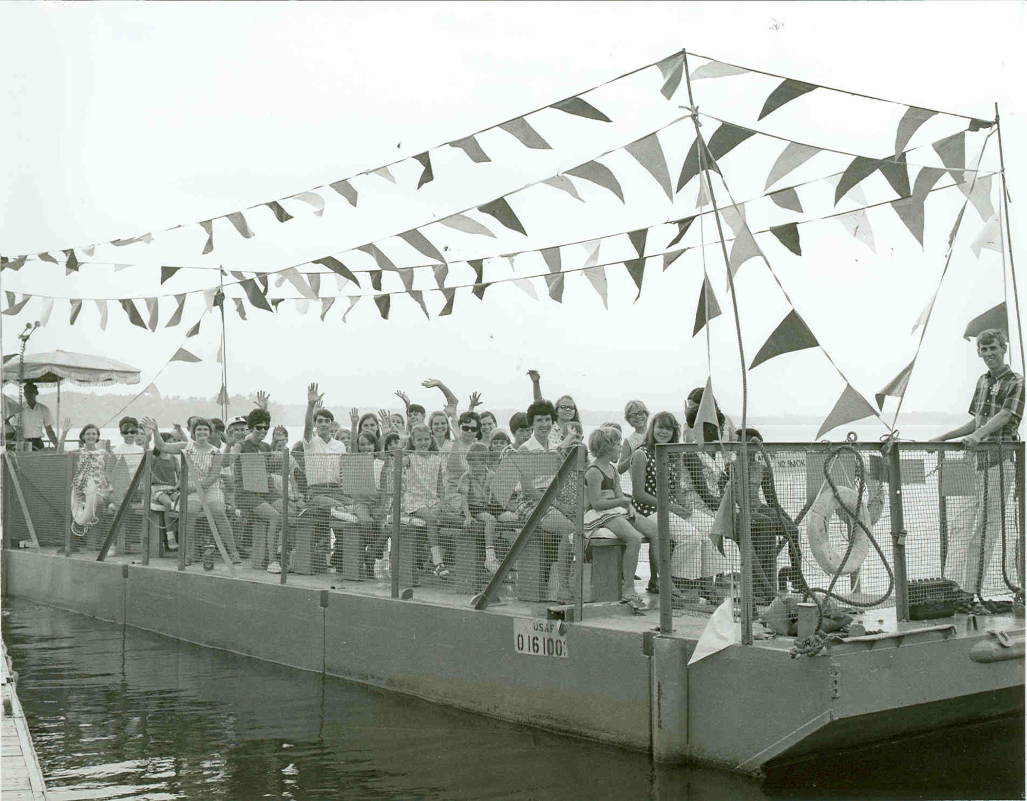 Attendees take part in a boat ride around Woods Reservoir during the annual Arnold Engineering Development Center Family Picnic in 1969. The reservoir, created by the 1952 completion of the Elk River Dam to supply cooling water to AEDC test facilities, opened for public fishing and recreation on May 30, 1953. Public use of the manmade lake was a topic of focus for then-AEDC Commander Brig. Gen. Samuel Harris following construction of the dam and leading up to the dedication of the waterbody as Woods Reservoir in July 1953. (U.S. Air Force photo)