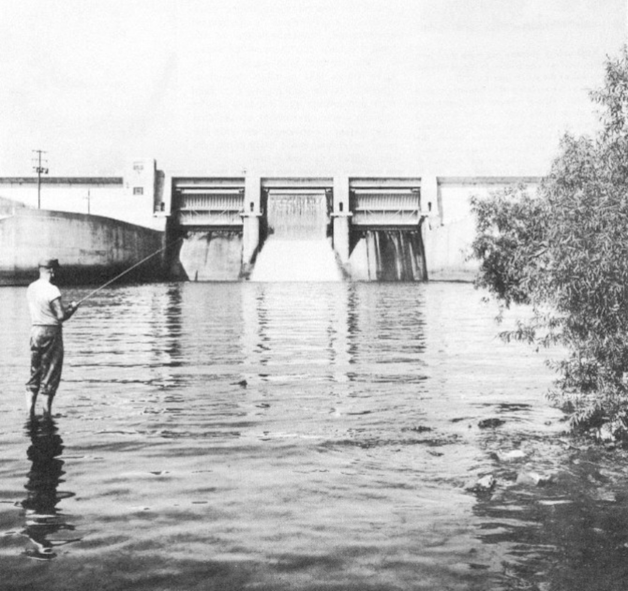 An angler fishes downstream of the Elk River Dam in the early 1960s. On the other side of the dam is Woods Reservoir. The reservoir, created by the 1952 completion of the Elk River Dam to supply cooling water to Arnold Engineering Development Center test facilities, opened for public fishing and recreation on May 30, 1953. Public use of the manmade lake was a topic of focus for then-AEDC Commander Brig. Gen. Samuel Harris following construction of the dam and leading up to the dedication of the waterbody as Woods Reservoir in July 1953. (U.S. Air Force photo)